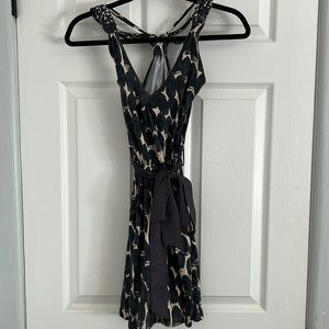 Short dress. Adjustable straps. Pockets. Ribbon tied around waist.